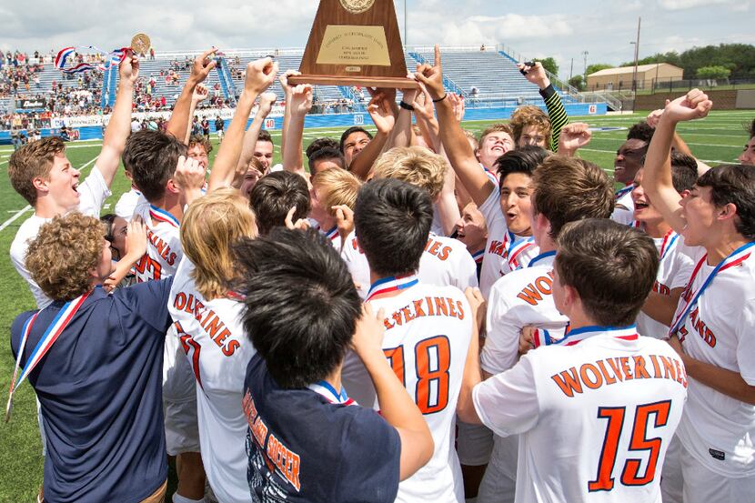 Frisco Wakeland players hoist up their trophy and celebrate after they beat Waller and...