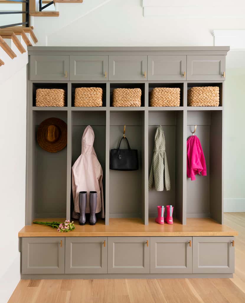 In this mudroom space of Kopfer's design, the bench is covered with  Benjamin Moore's...