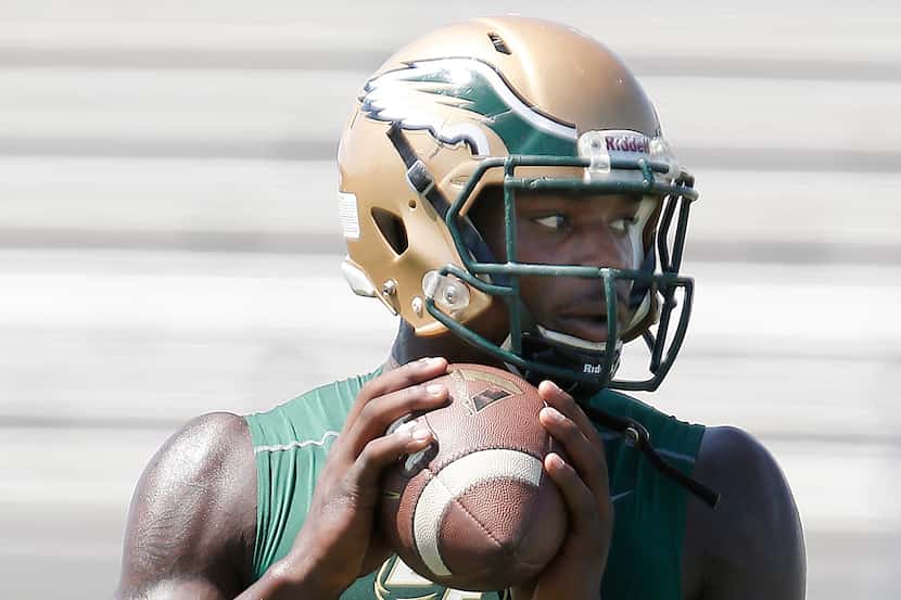 DeSoto senior quarterback Tristen Wallace looks to pass to a teammate during the teams first...