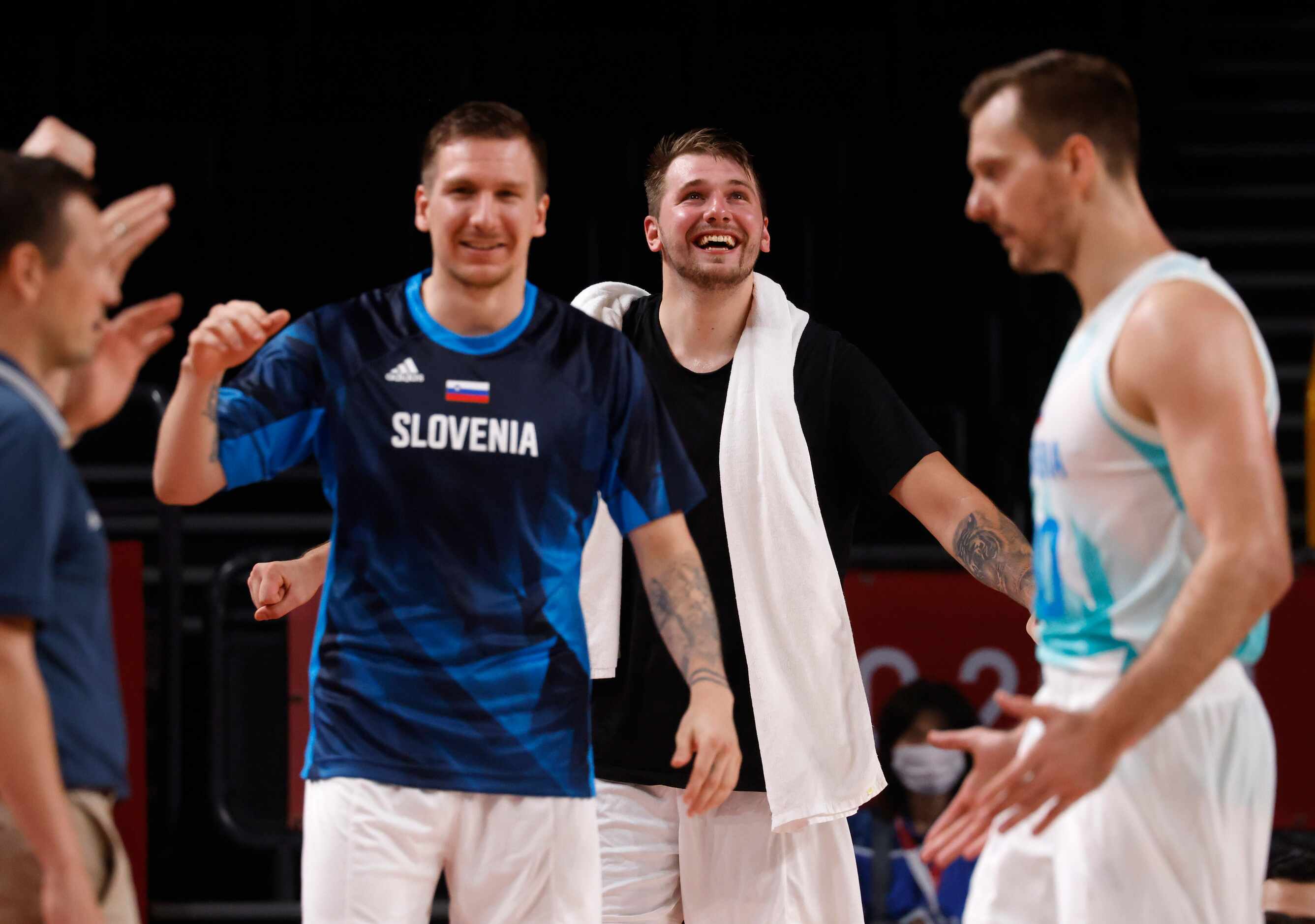 Slovenia’s Luka Doncic (77) and teammates celebrate after a made basket in a game against...