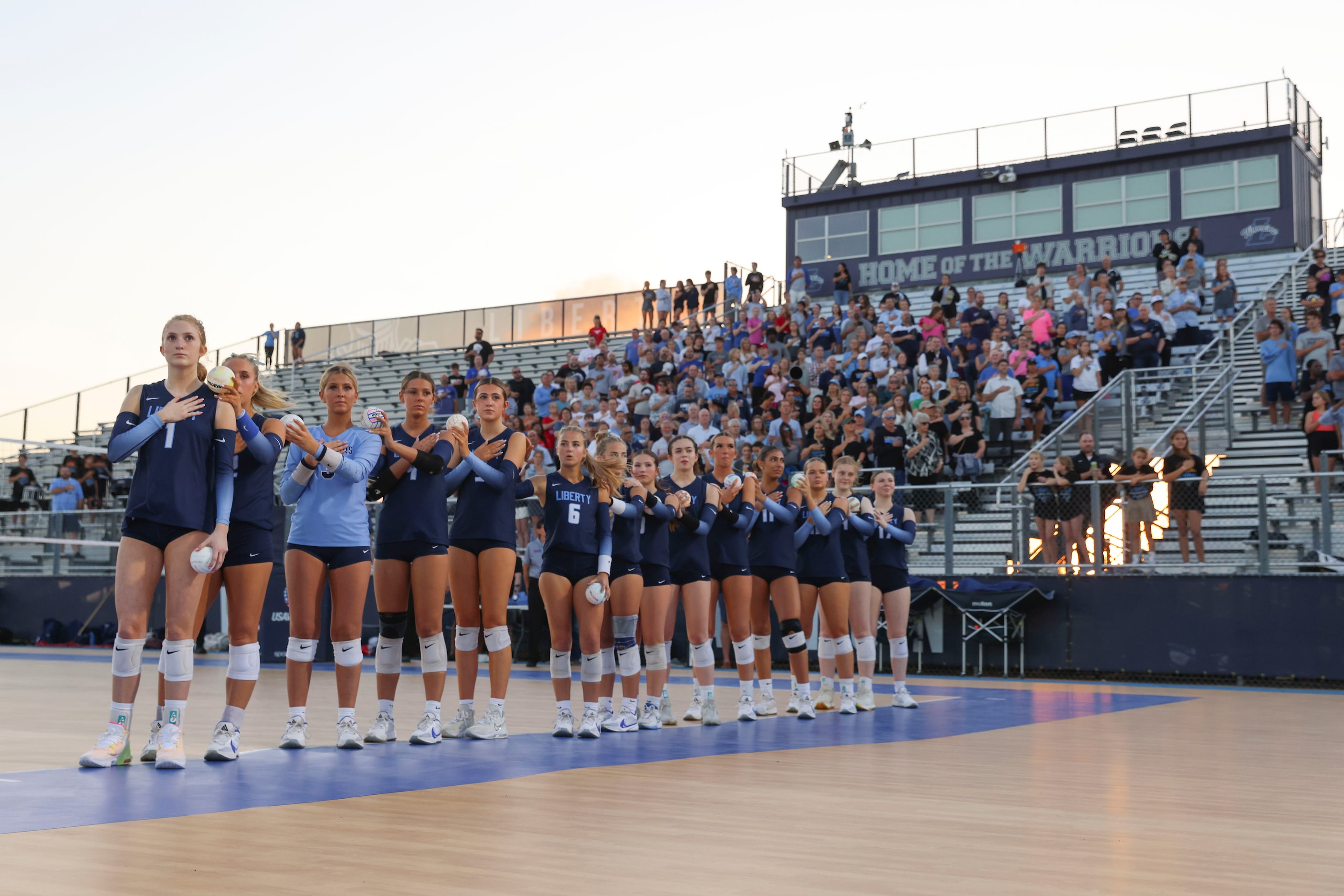  Liberty Christian School players alongside the crowd stand during the National Anthem ahead...