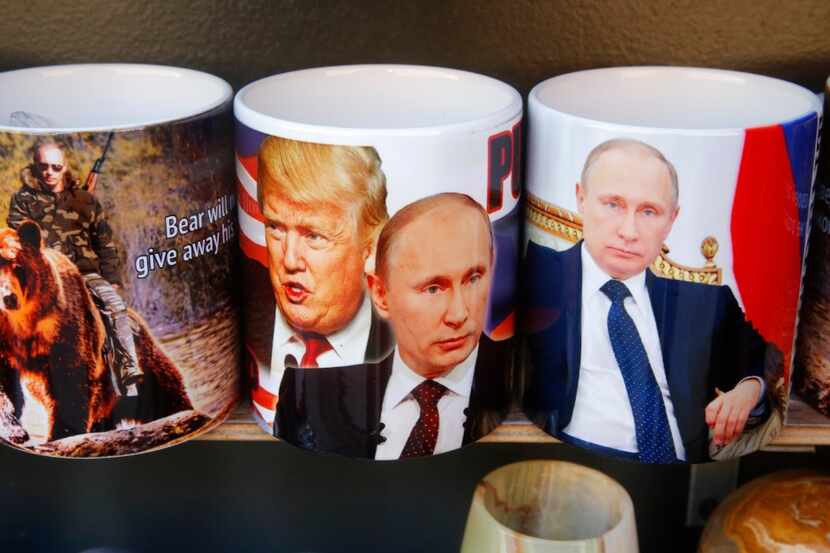 FILE - A Friday, Jan. 20, 2017 file photo cups depicting Russian President Vladimir Putin...