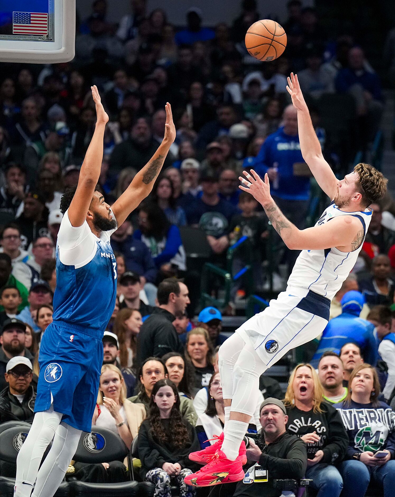 Dallas Mavericks guard Luka Doncic (77) shoots over Minnesota Timberwolves center...