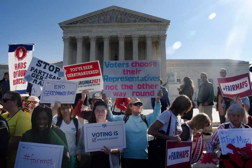 Demonstrators gathered outside the U.S. Supreme Court on Tuesday during oral arguments in...