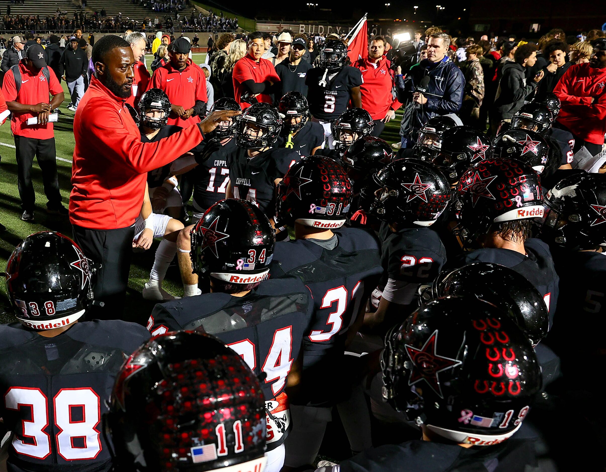 Coppell head coach Antonio Wiley talks with his team after beating Denton Guyer, 35-21 in...