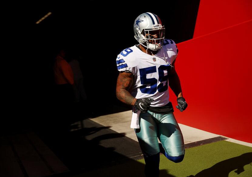 FILE - Dallas Cowboys middle linebacker Anthony Hitchens (59) heads to the field before the...