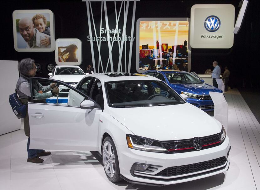 Attendees look at the Volkswagen Jetta during the 2017 North American International Auto...