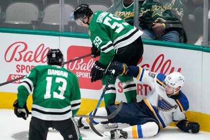 Dallas Stars center Riley Damiani (13) and defenseman Artem Grushnikov (59) combine to strip...