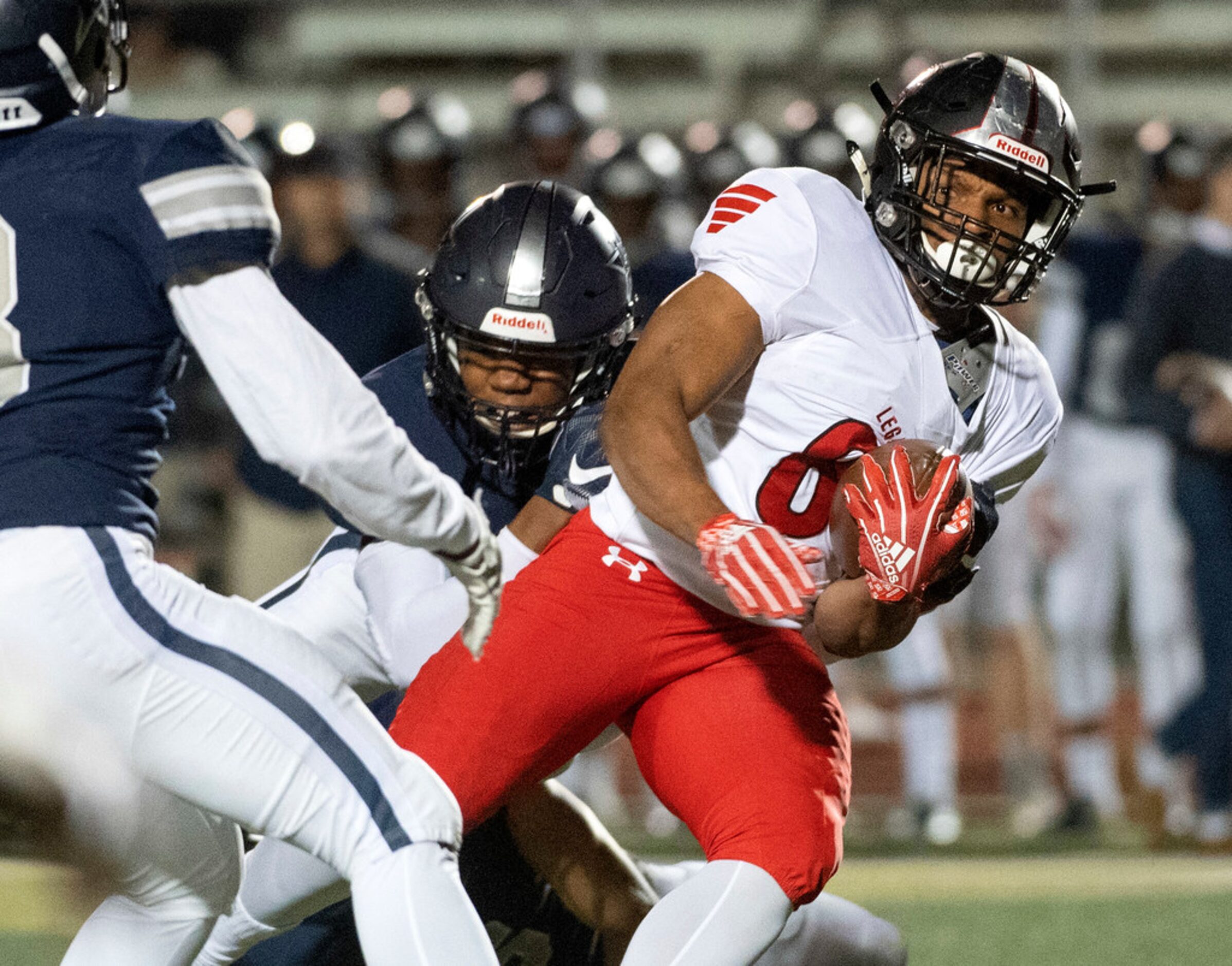 Mansfield Legacy running back Kaleb King (8) tries to escape the tackle of Frisco Lone Star...