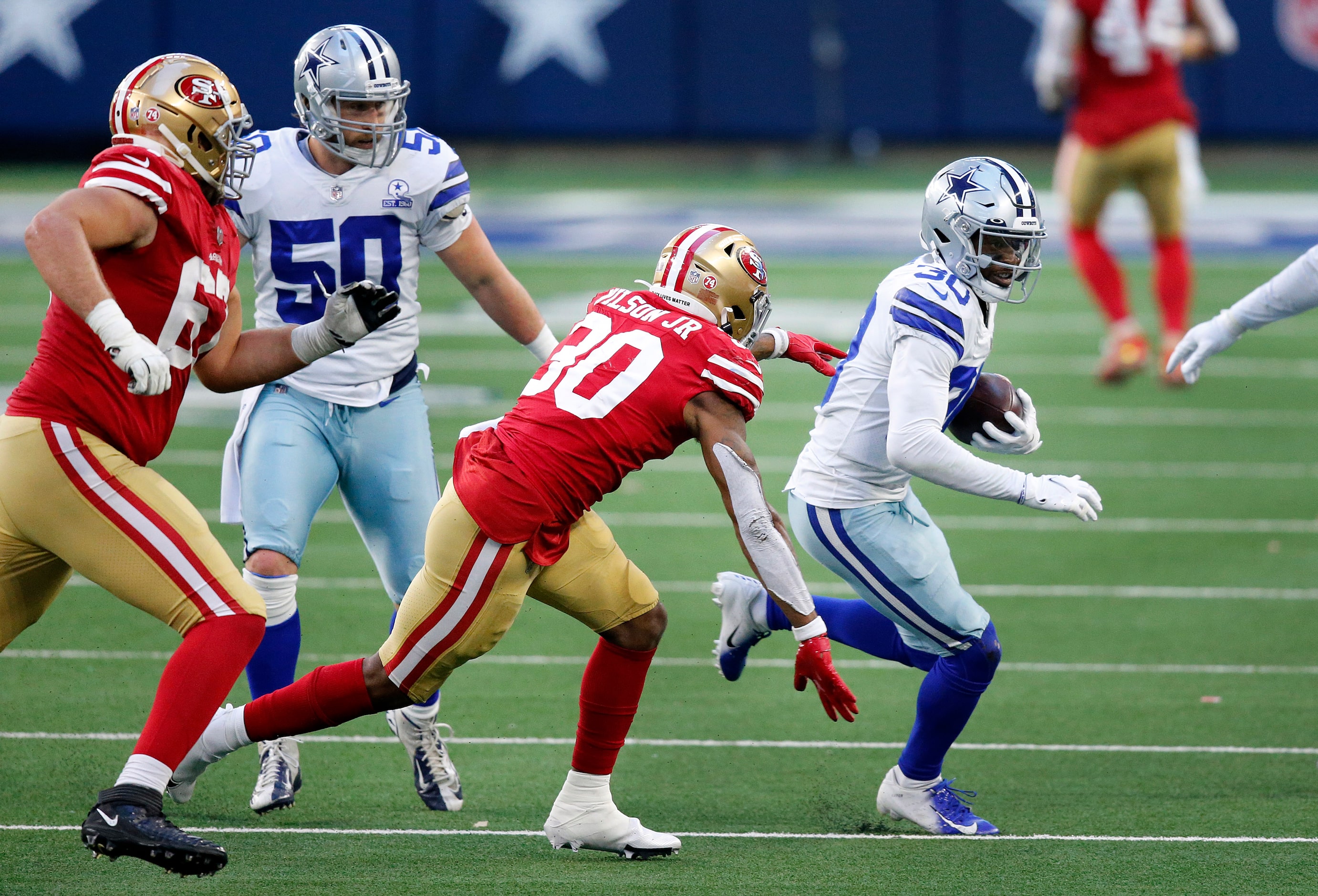 Dallas Cowboys cornerback Anthony Brown (30) races away from San Francisco 49ers running...