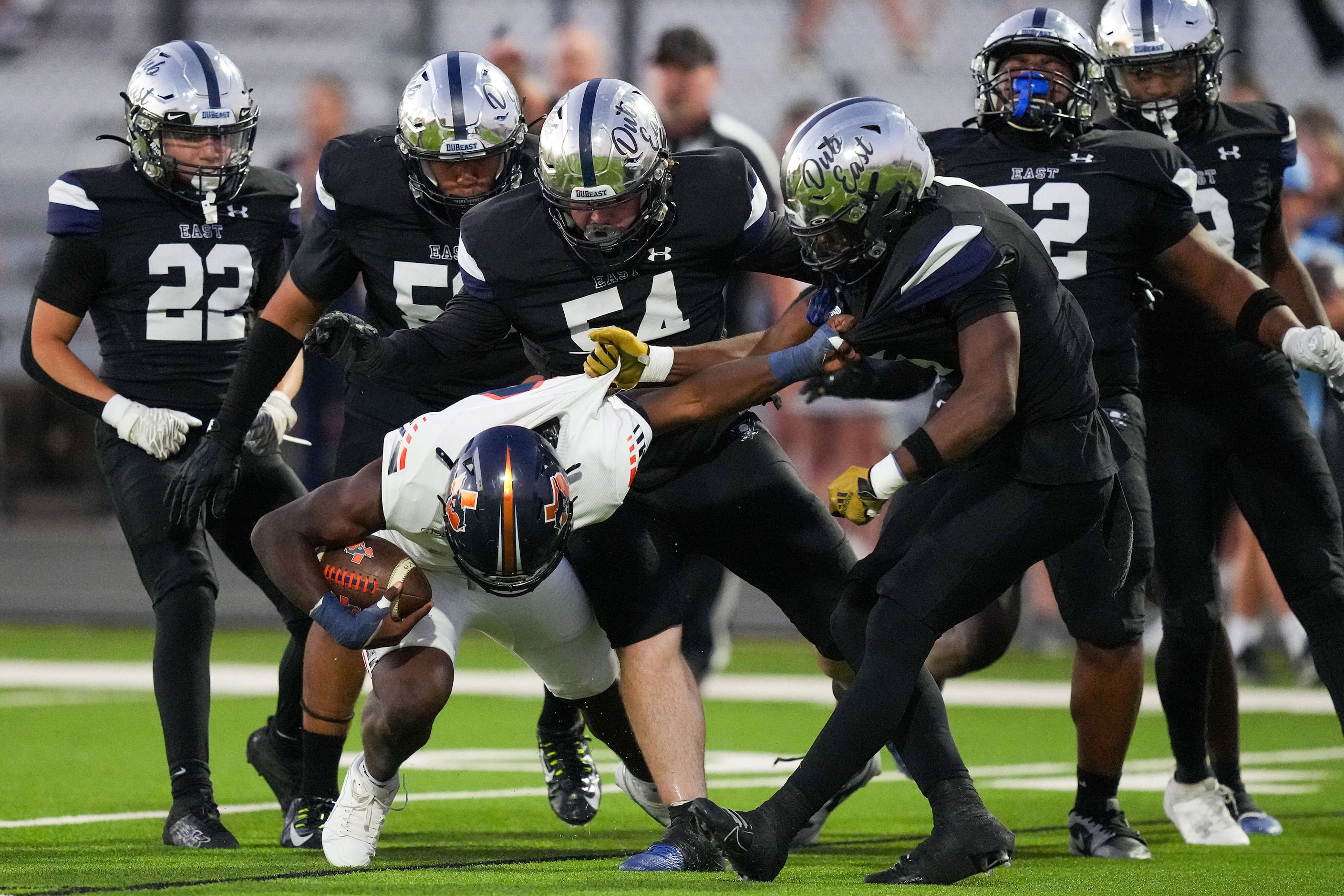 Sachse running back Brendon Haygood (0) is brought down by Wylie East linebacker Rome...