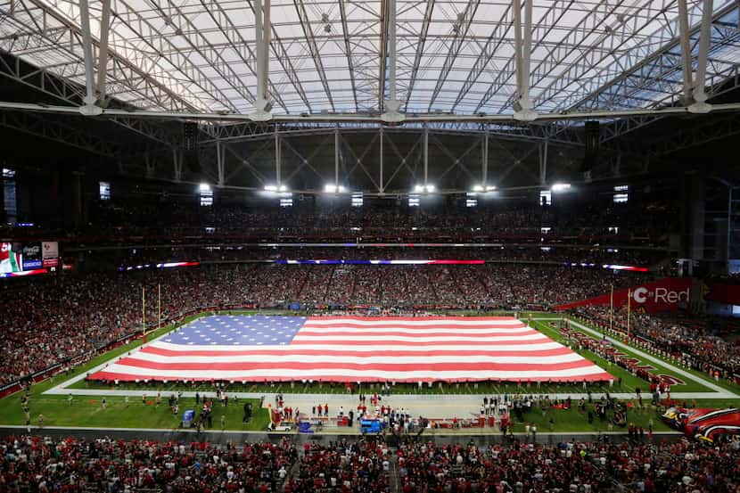 A field-sized flag is displayed during the National Anthem prior to the start of a game...