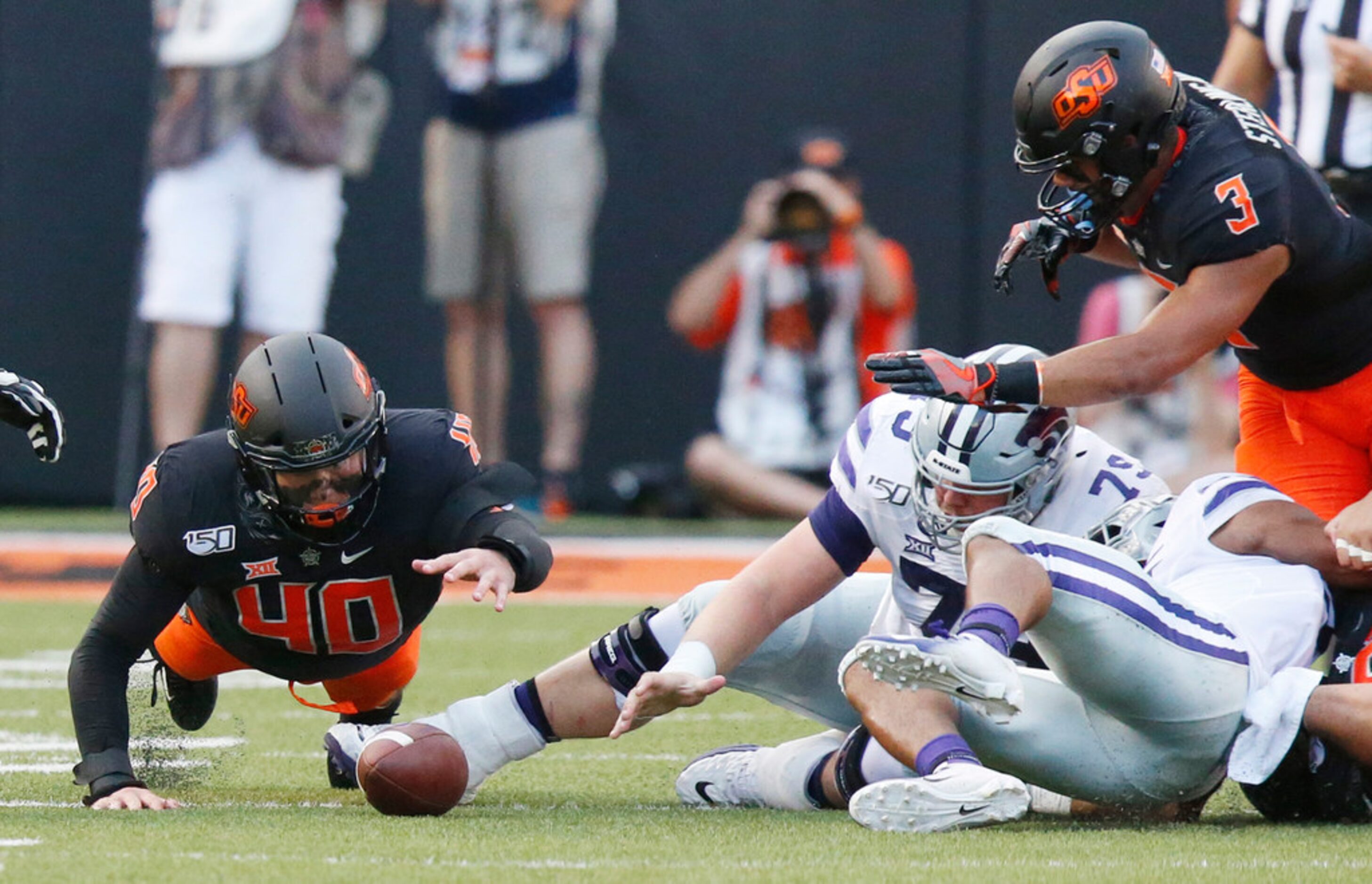 Oklahoma State defensive end Brock Martin (40) dives for a K-State fumble in the first half...