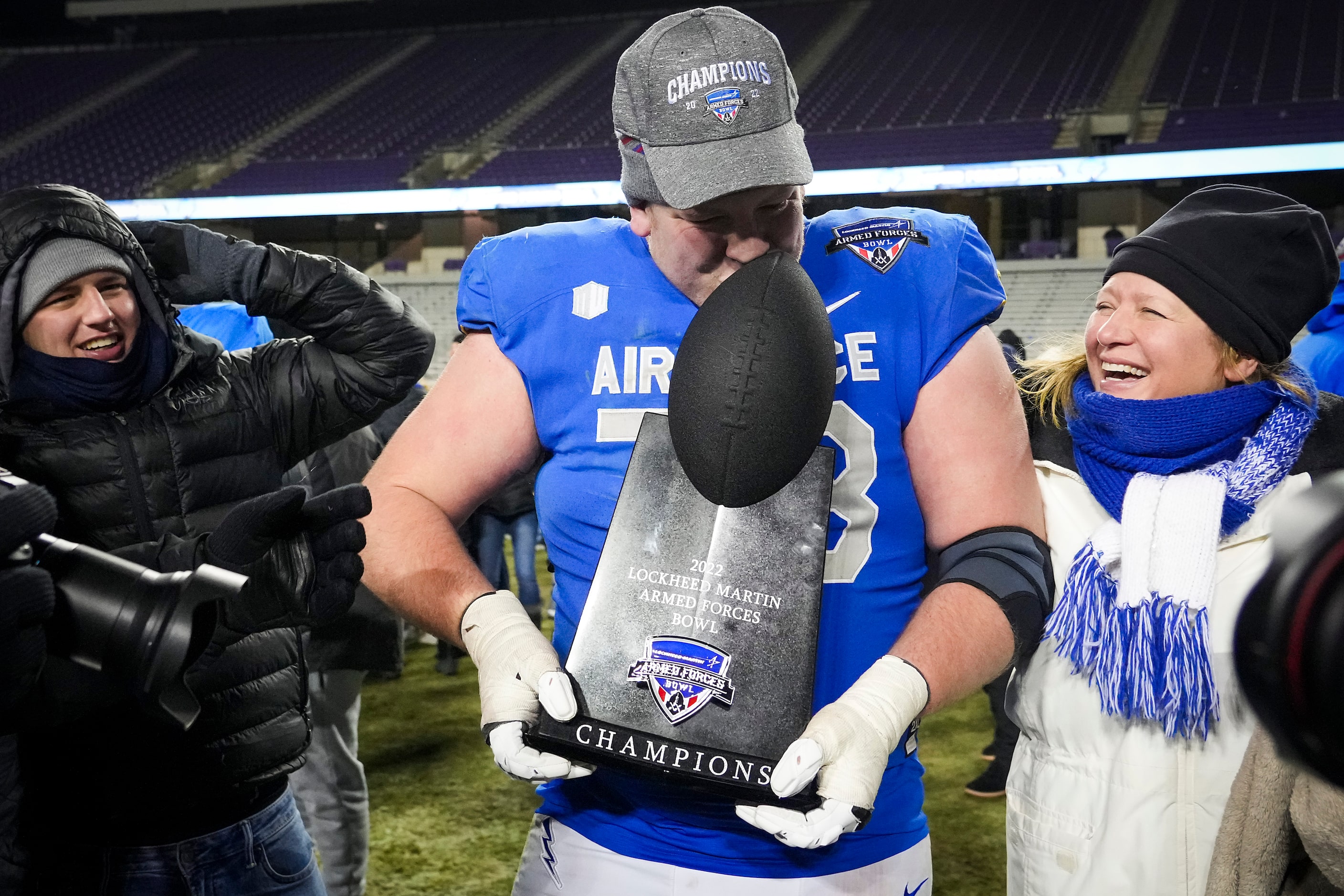 Air Force offensive lineman Isaac Cochran kisses the trophy after a victory over Baylor in...