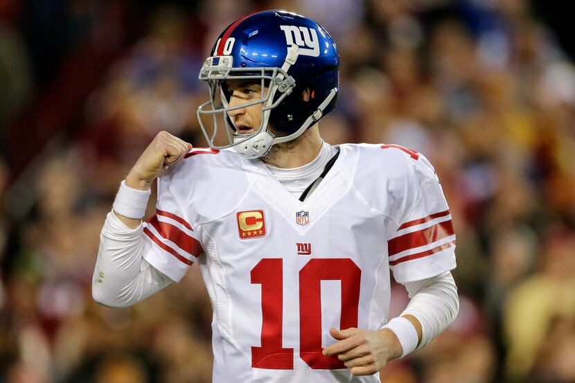 New York Giants quarterback Eli Manning celebrates running back Rashad Jennings' touchdown...