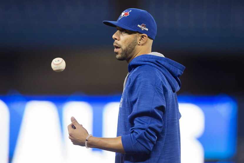 Toronto Blue Jays pitcher David Price flips a ball during a baseball practice in Toronto,...