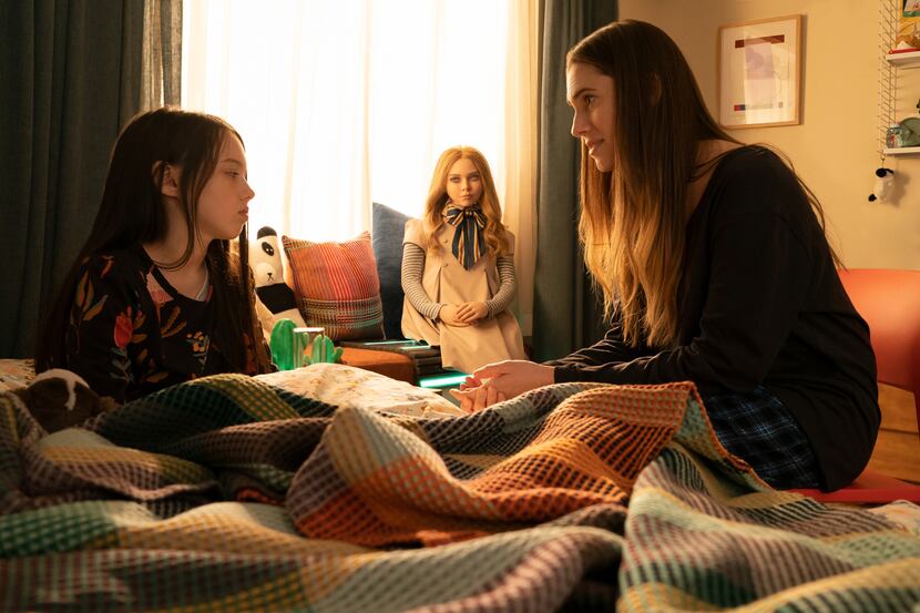Violet McGraw, left, as Cady, M3GAN, and Allison Williams as Gemma in "M3GAN," directed by...