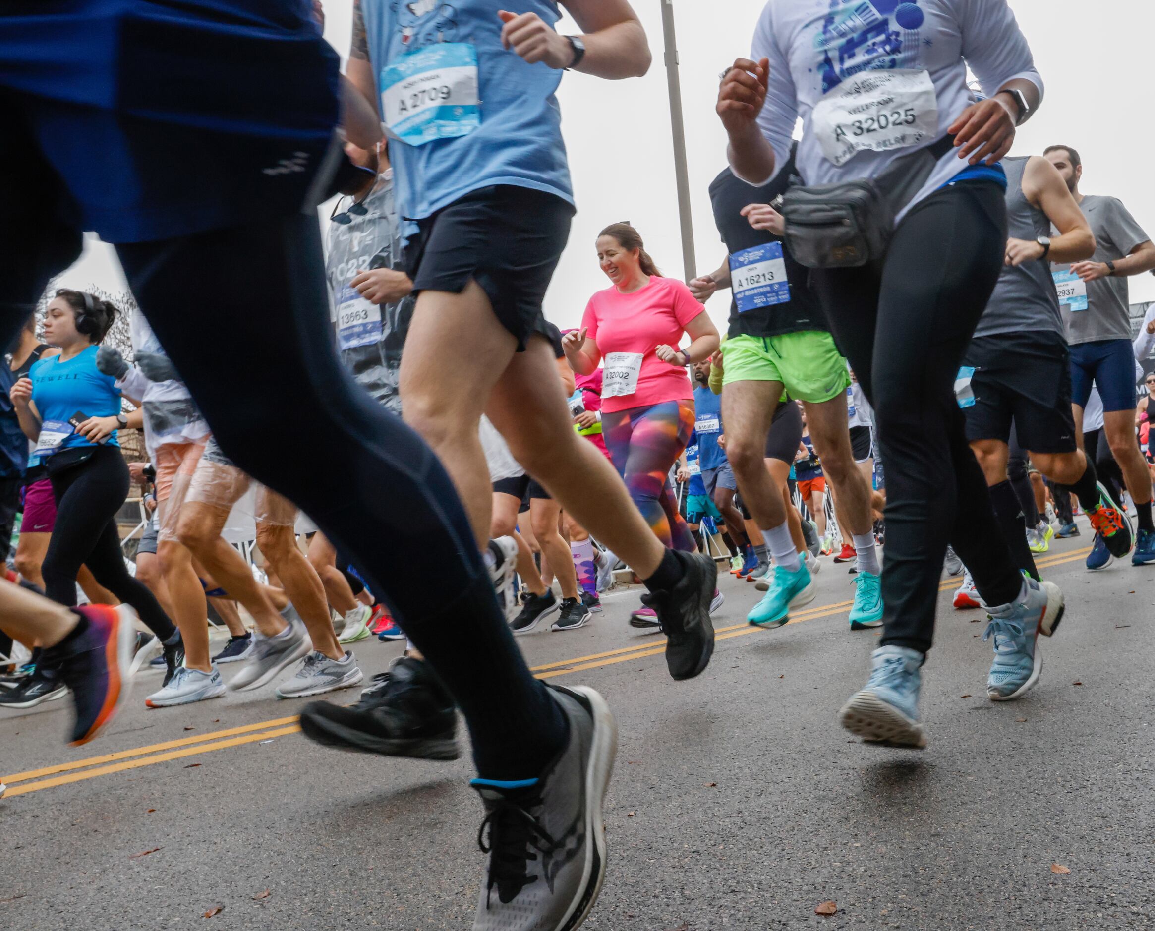 Runners make their way down Marilla Street on the first leg of the BMW Dallas Marathon on...