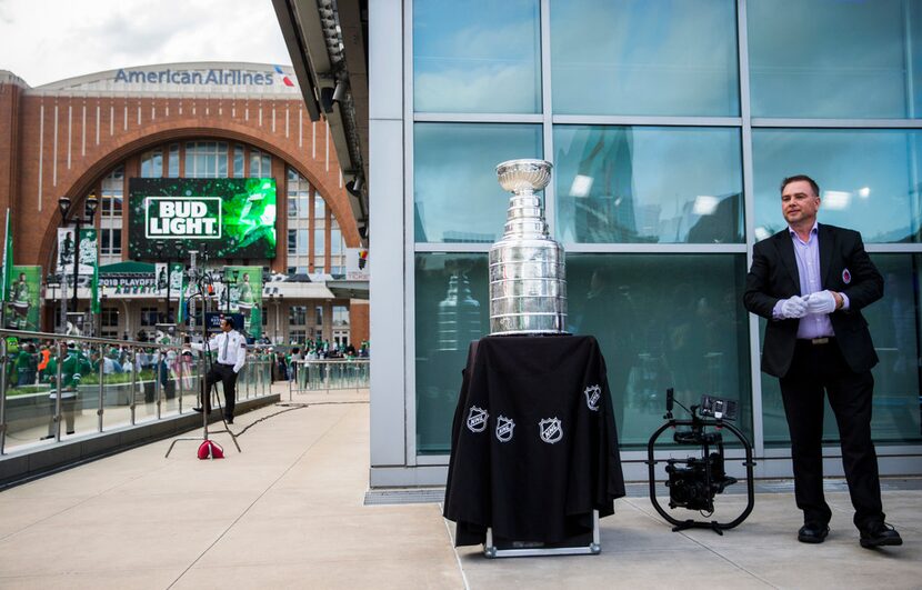 Stanley Cup keeper Howie Borrow (right) stands with the Stanley Cup outside American...