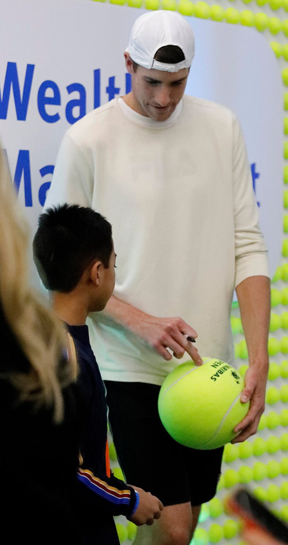 Local pro John Isner signs an autograph as he was on hand to announce his upcoming event to...