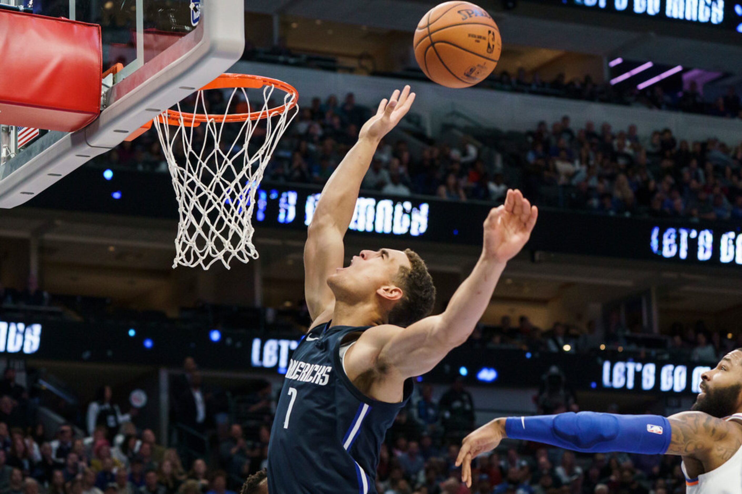 Dallas Mavericks forward Dwight Powell (7) is fouled by New York Knicks guard RJ Barrett (9)...