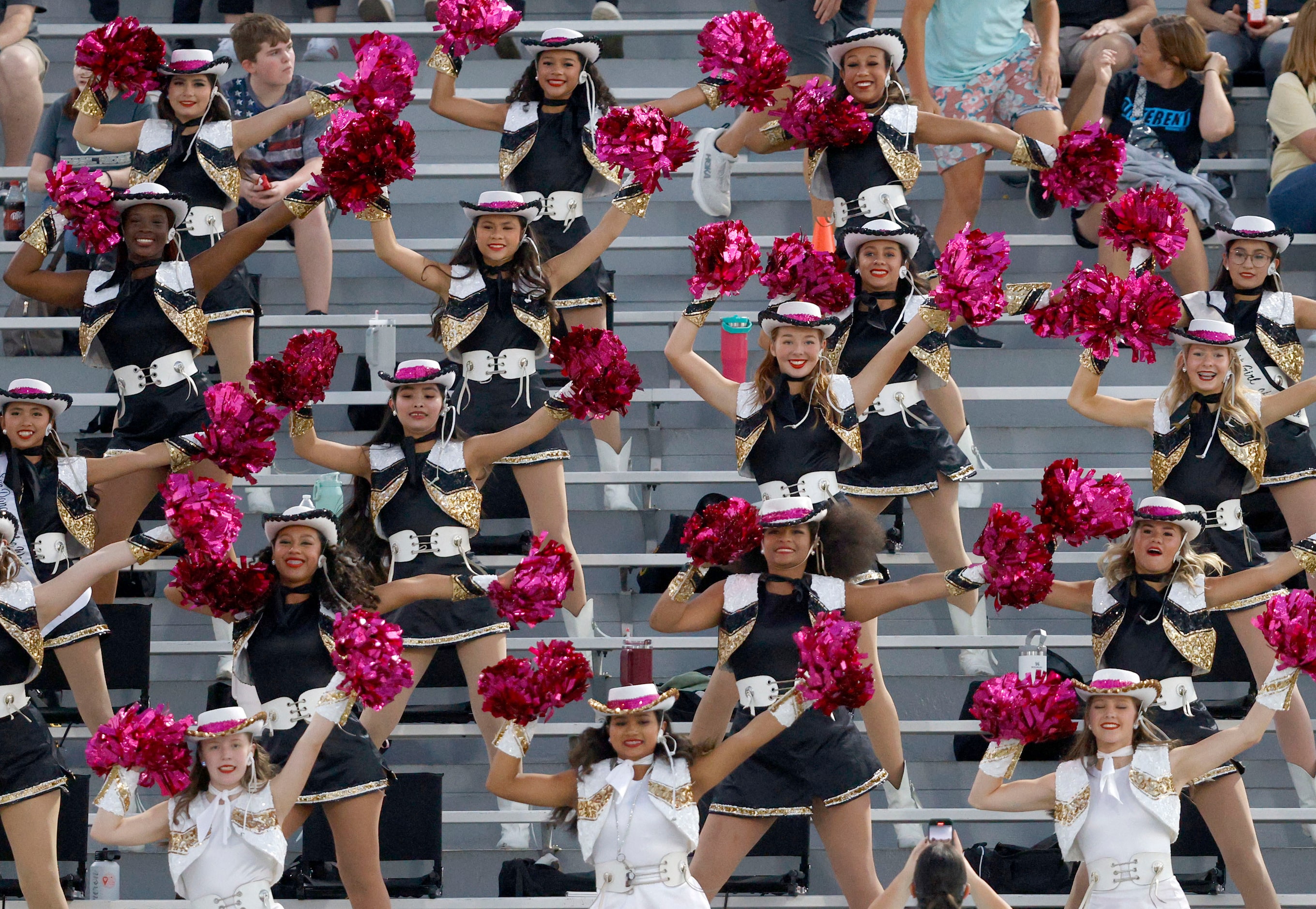 Fossil Ridge dance team members perform in the first half of a high school football game...