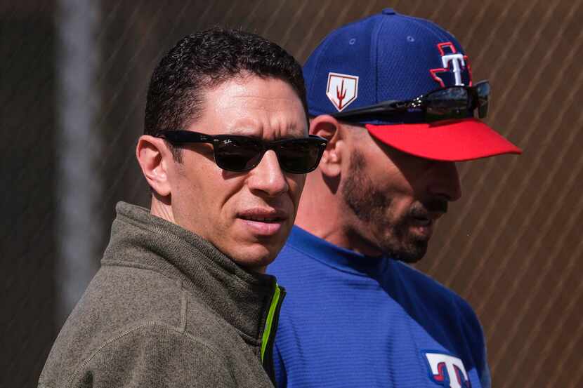 FILE - Rangers GM Jon Daniels (left) and manager Chris Woodward watch batting practice...
