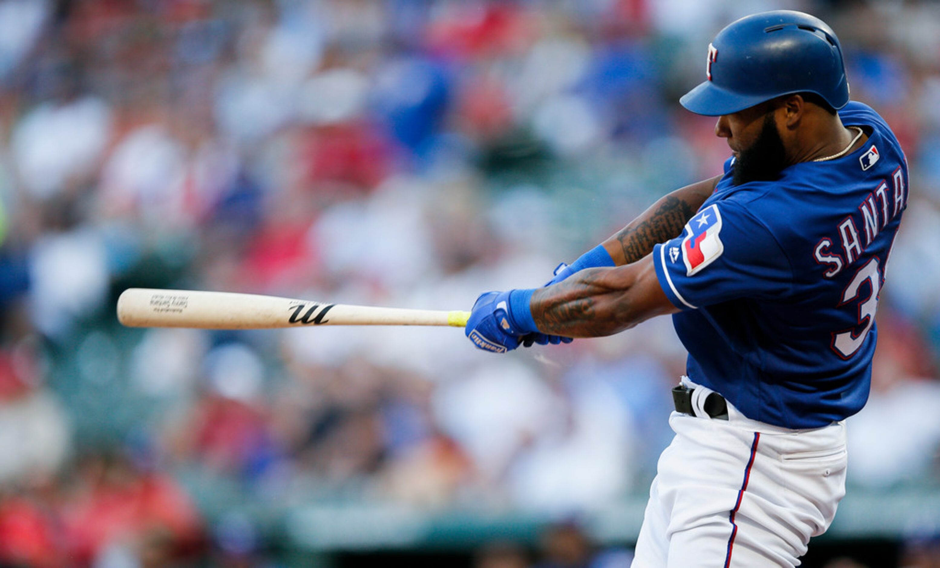 Texas Rangers' Danny Santana makes contact for a solo home run during the second inning of a...