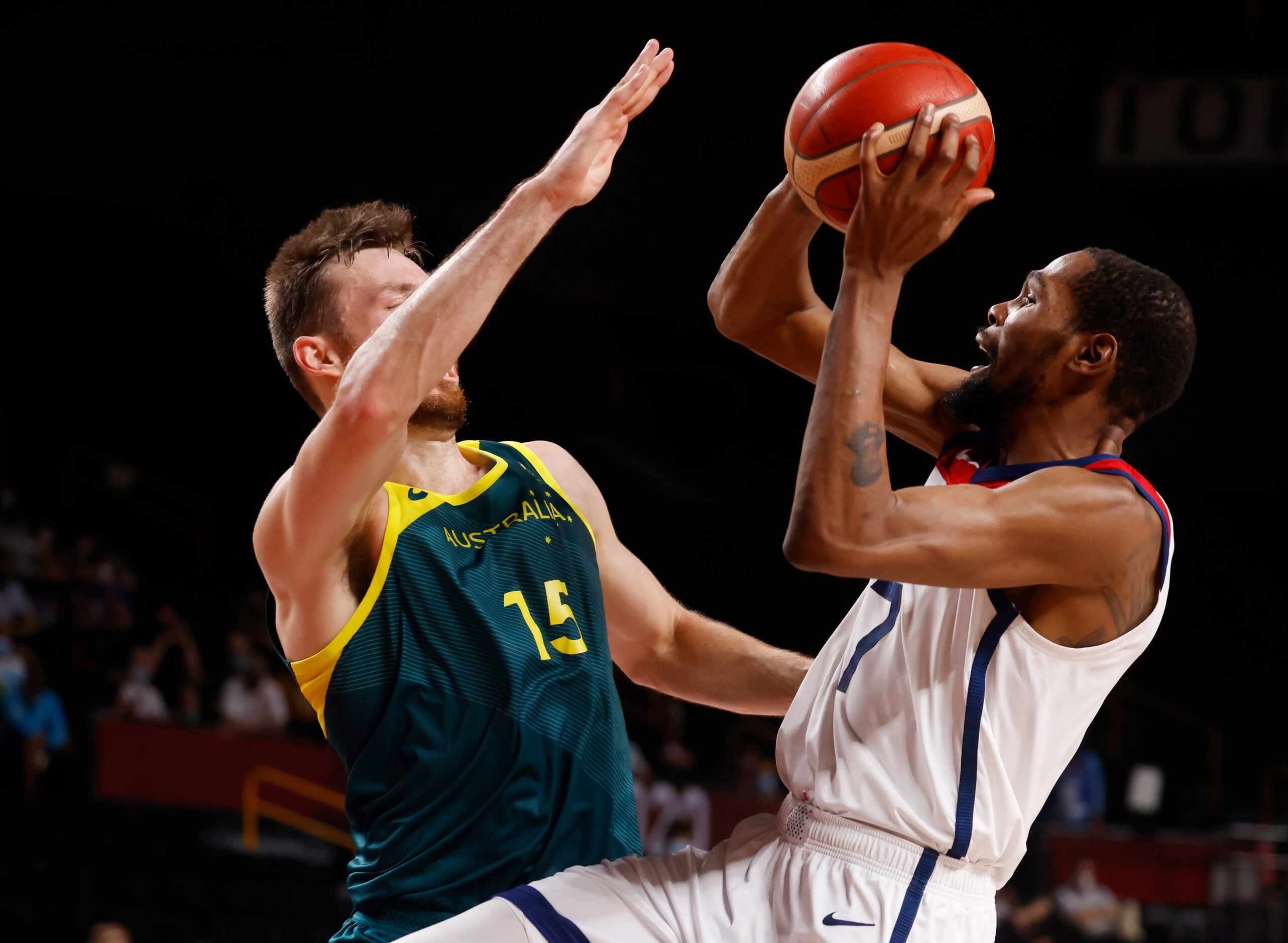 USA’s Kevin Durant (7) shoots as he is defended by Australia’s Nic Kay (15) during the first...