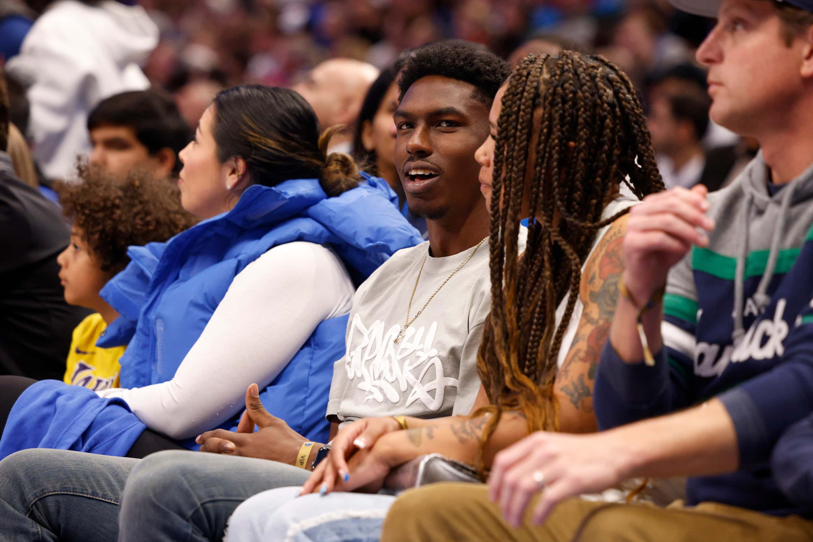 Dallas Cowboys cornerback Daron Bland watches the first half of an NBA game between the...