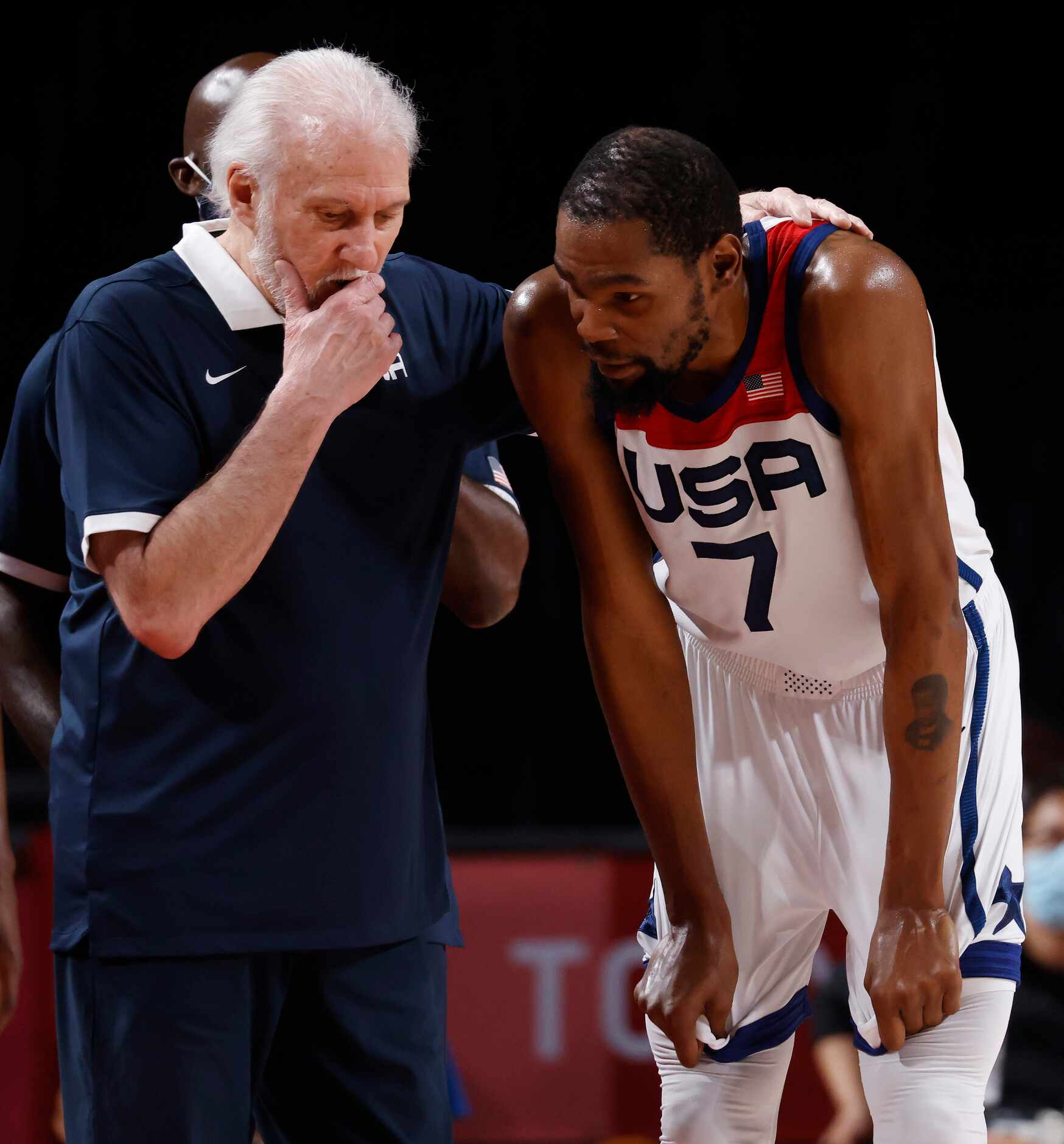 USA’s head coach Gregg Popovich talks to Kevin Durant (7) during a break in play against...
