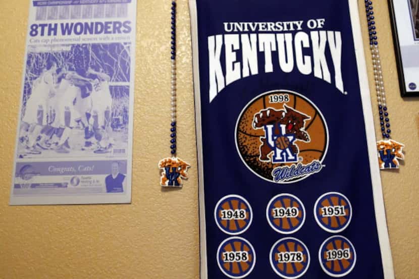 Newspaper clippings and other Kentucky items hang on the wall in a room in the home of...