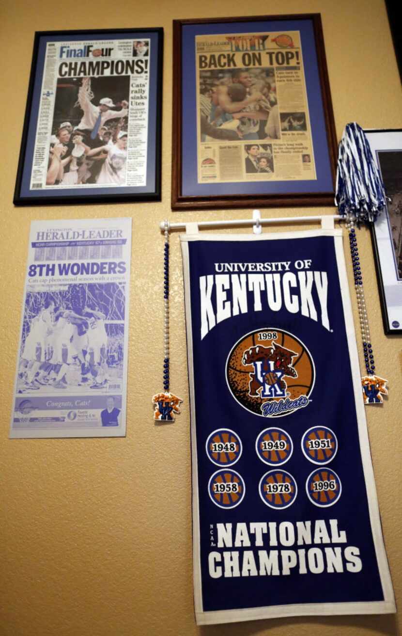 Newspaper clippings and other Kentucky items hang on the wall in a room in the home of...