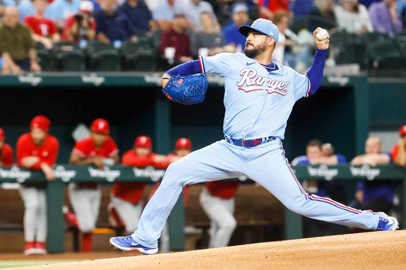 Texas Rangers starting pitcher Martin Perez throws during the first inning of a baseball...