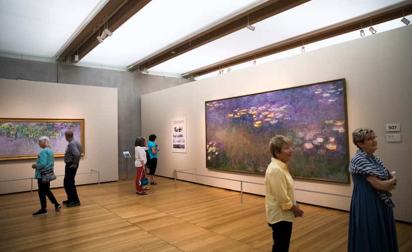 Museum-goers view  "Water Lilies" paintings by Claude Monet as part of the Monet: The Late...