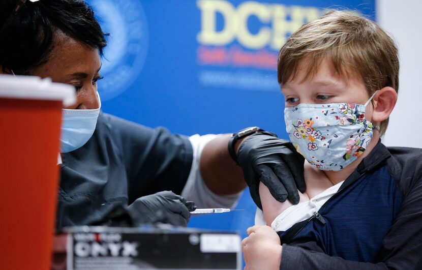 Immunization program supervisor and registered nurse Barbara Davis, gave Finn Good, 9, a...