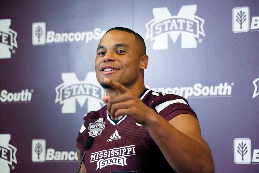 Mississippi State quarterback Dak Prescott smiles at a question from reporters about the...