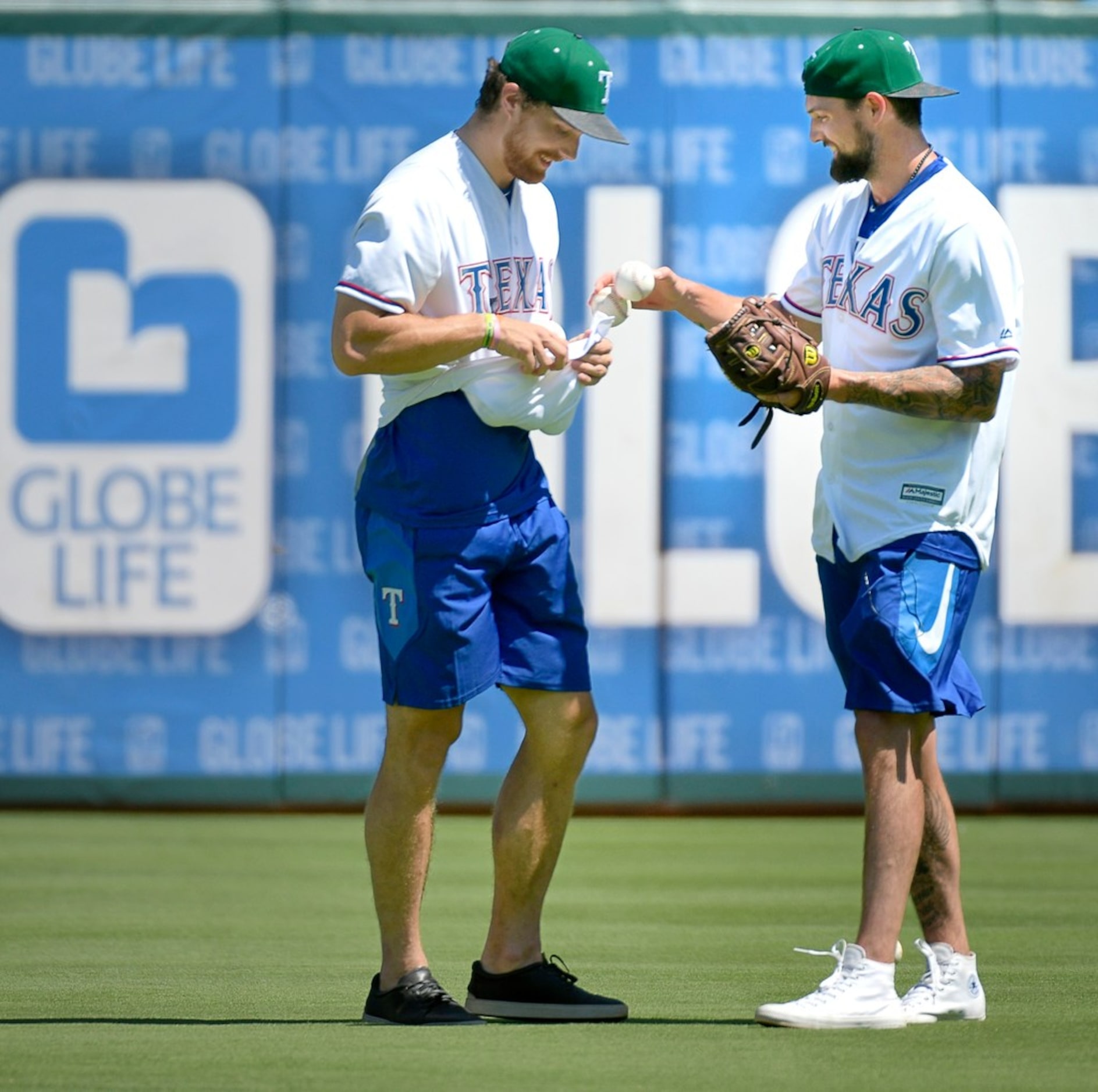 Dallas Stars Stephen Johns, left, and team captain Jamie Benn pick up balls during batting...