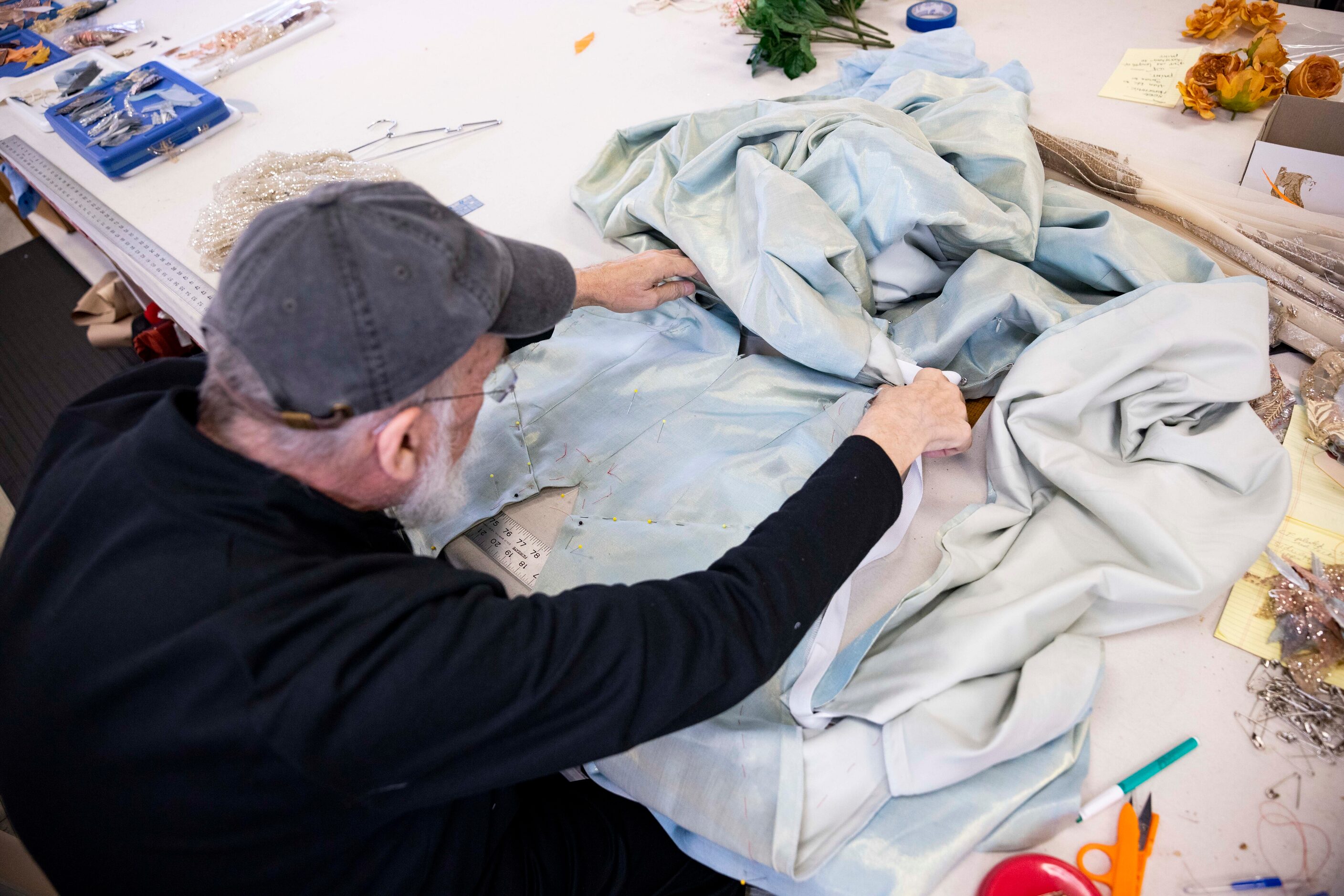 John Ahrens alters a costume for Dallas Opera’s Das Rheingold on Wednesday, Jan. 18, 2023,...