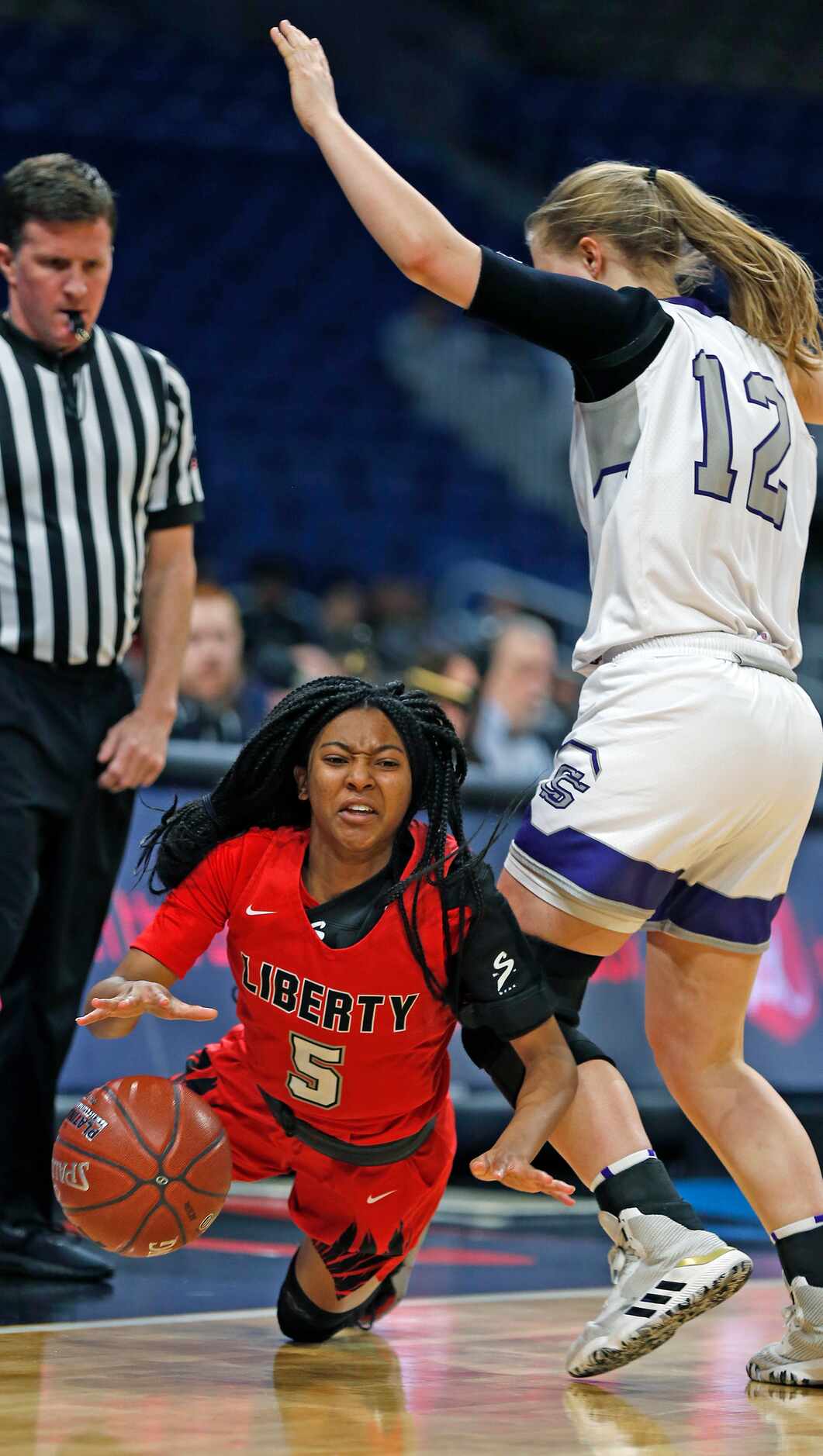 Frisco Liberty guard Zoe Junior #5 is fouled by College Station guard Rebekah Hailey #12 in...