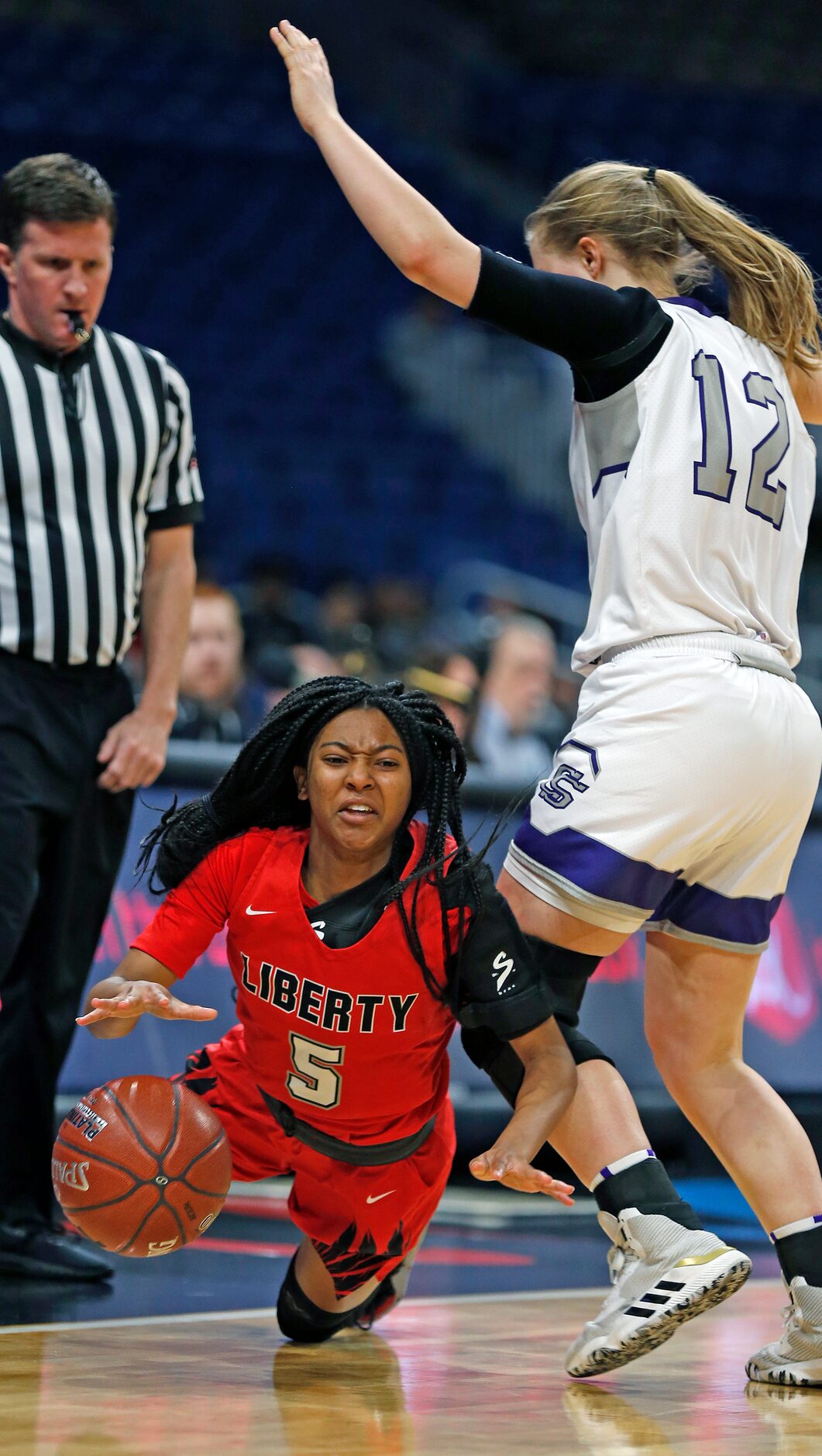 Frisco Liberty guard Zoe Junior #5 is fouled by College Station guard Rebekah Hailey #12 in...