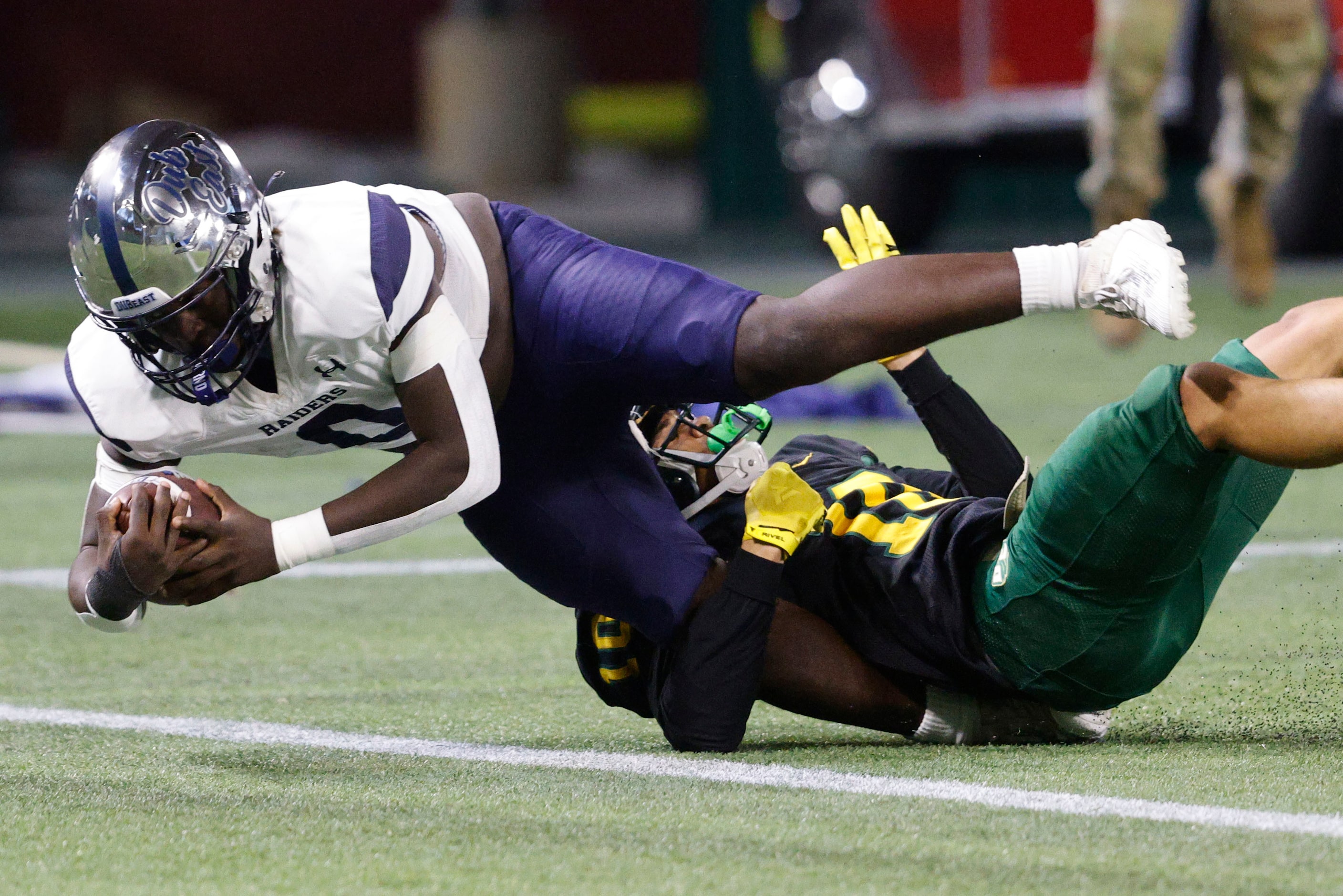 Wylie East's Keveyon Thorne (0) scores a touchdown over DeSoto's Makali Mckellar (10) during...