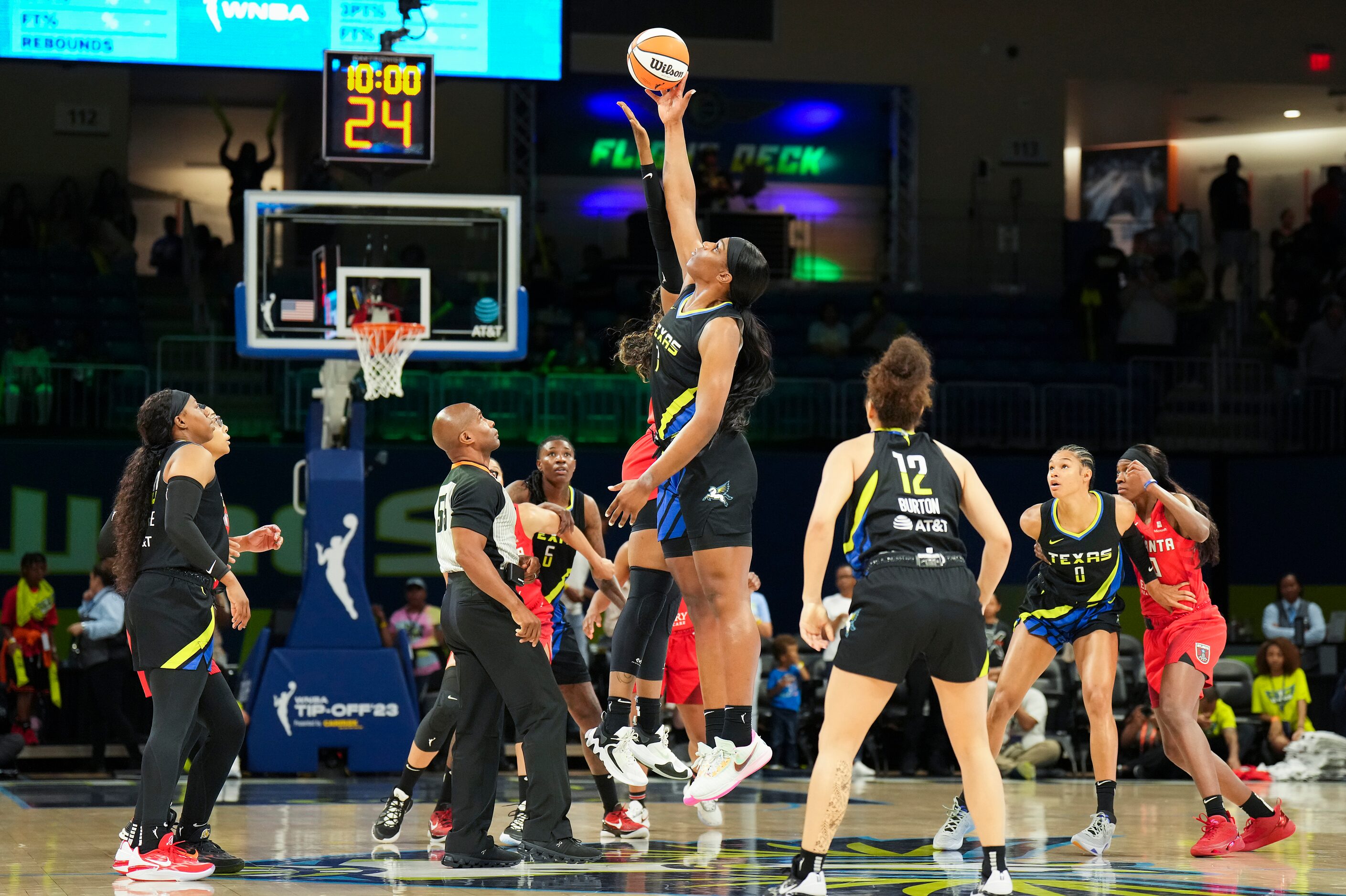 Dallas Wings center Teaira McCowan (7) wins the opening tipoff of a WNBA basketball game...