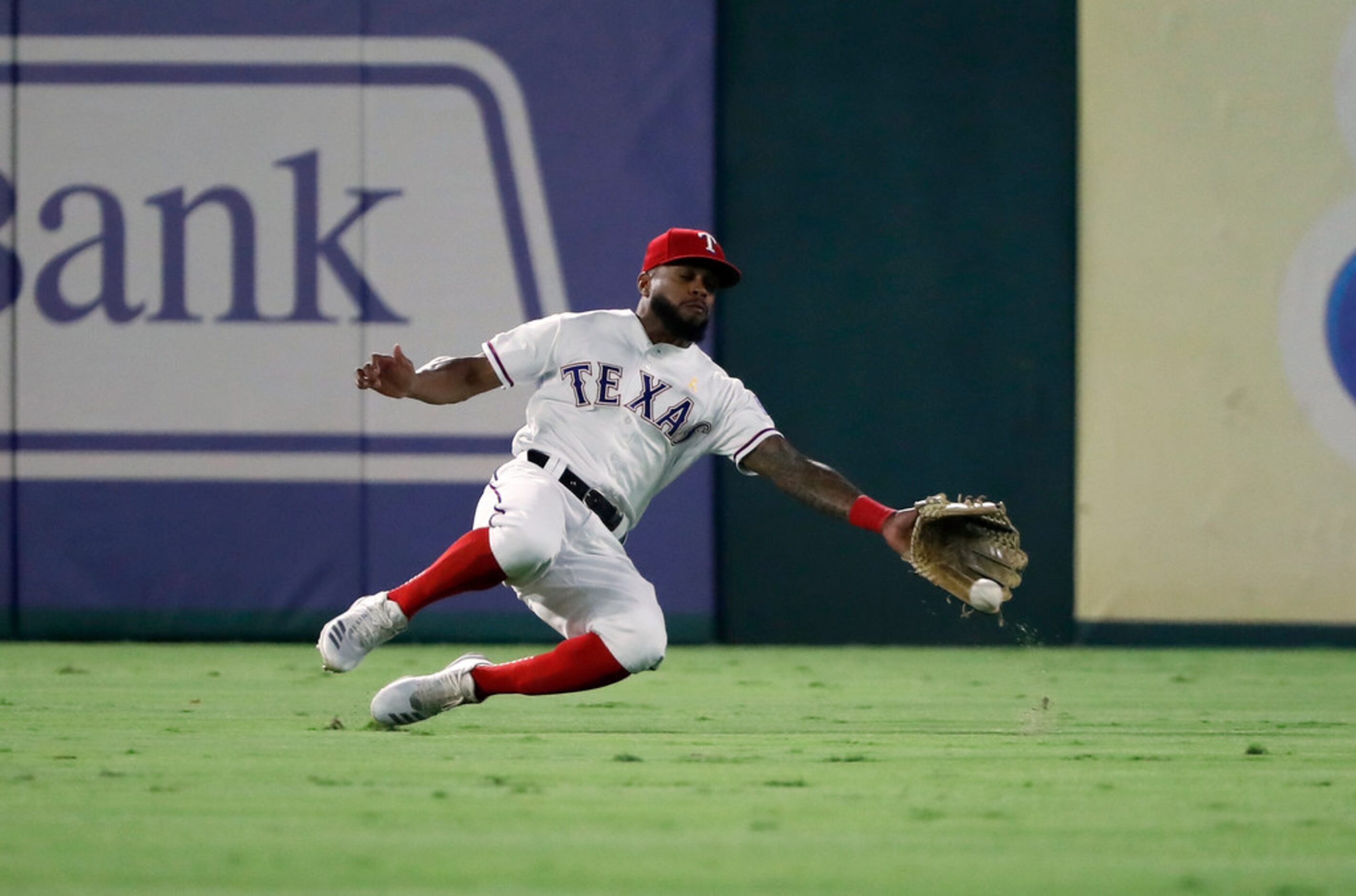 Texas Rangers center fielder Delino DeShields (3) is unable to reach a single on a sliding...