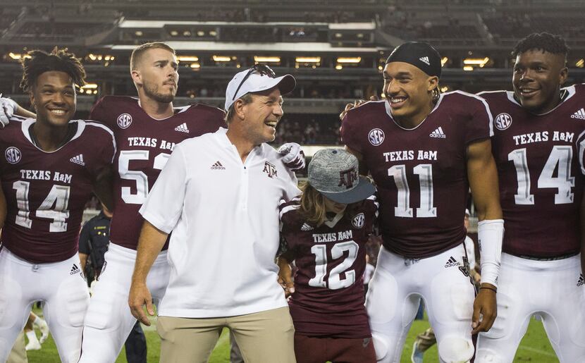 Texas A&M Aggies head coach Jimbo Fisher, joined by his son Ethan Fisher (wearing jersey...