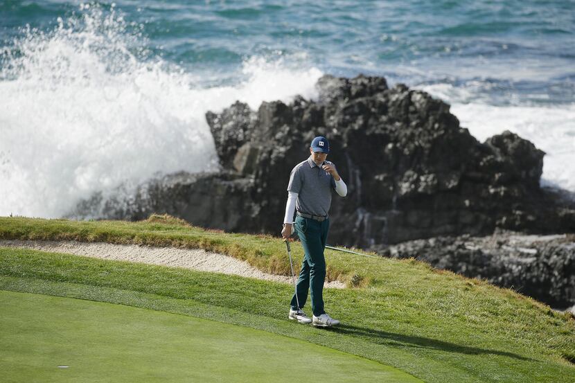 Jordan Spieth looks over the seventh green of the Pebble Beach Golf Links during the third...