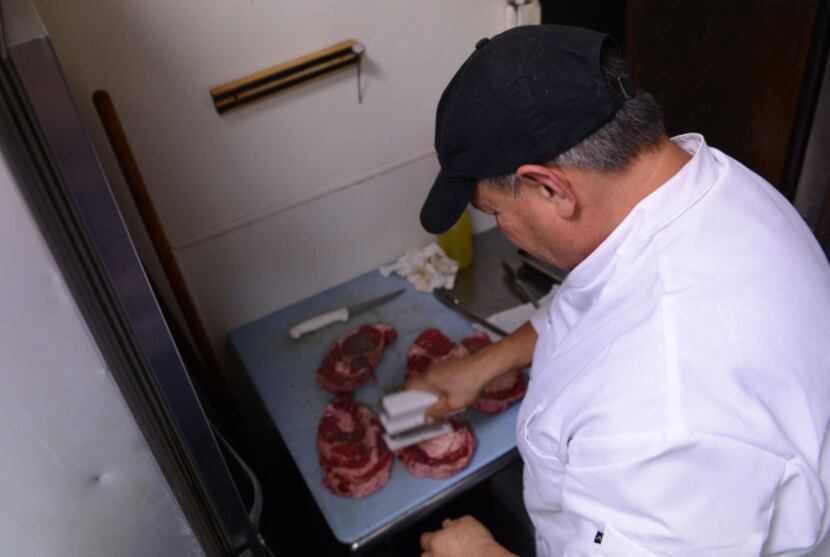 Florentino Echeverria prepares meat at Chamberlain's Steak and Chop House in Addison. The...