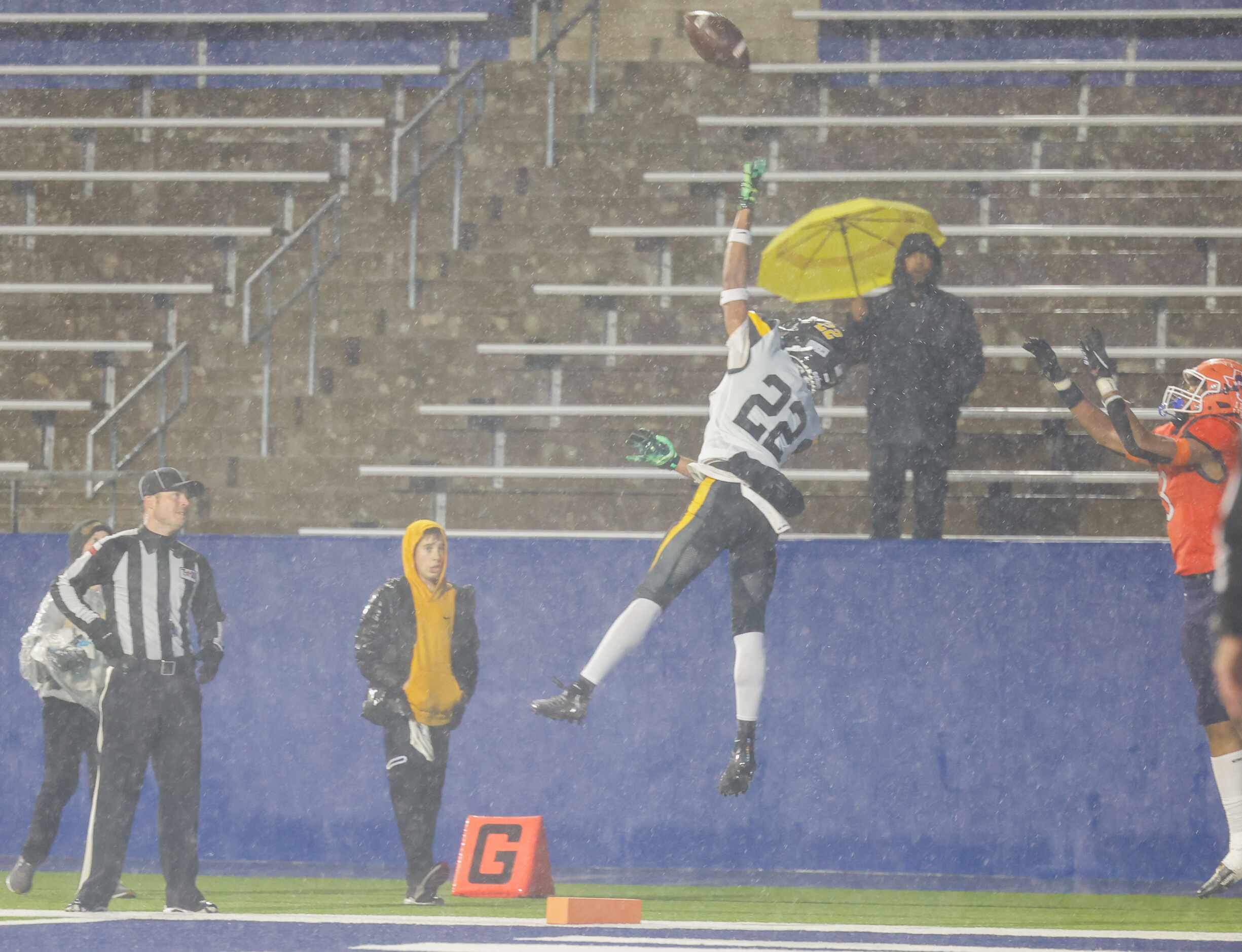 Forney defensive back Joshua Gatlin (22) and McKinney North wide receiver Kameron Powell (3)...