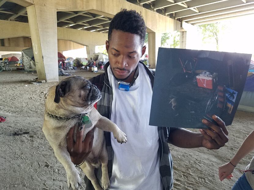 Gary Pearson, 23, with one of his photos and his neighbor's pug, Steven Seagal, at their...