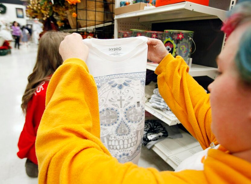 Destiny Rucker  stocks Day of the Dead merchandise at Michaels in Mesquite. “Michaels...